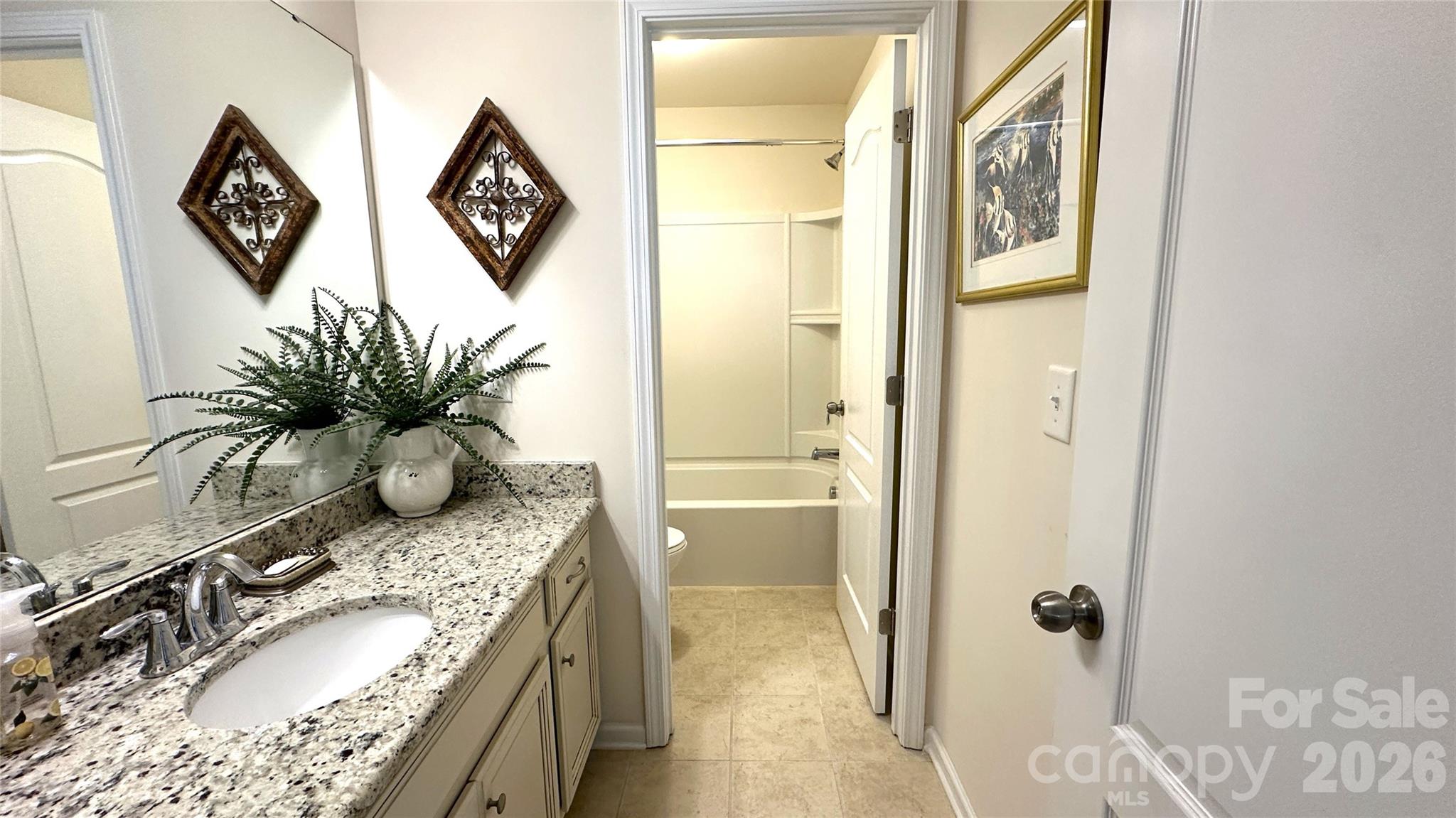 596 Moses Drive Fort Mill, SC 29707 - Photo 21 of 29 a bathroom with a granite countertop sink a mirror and shower