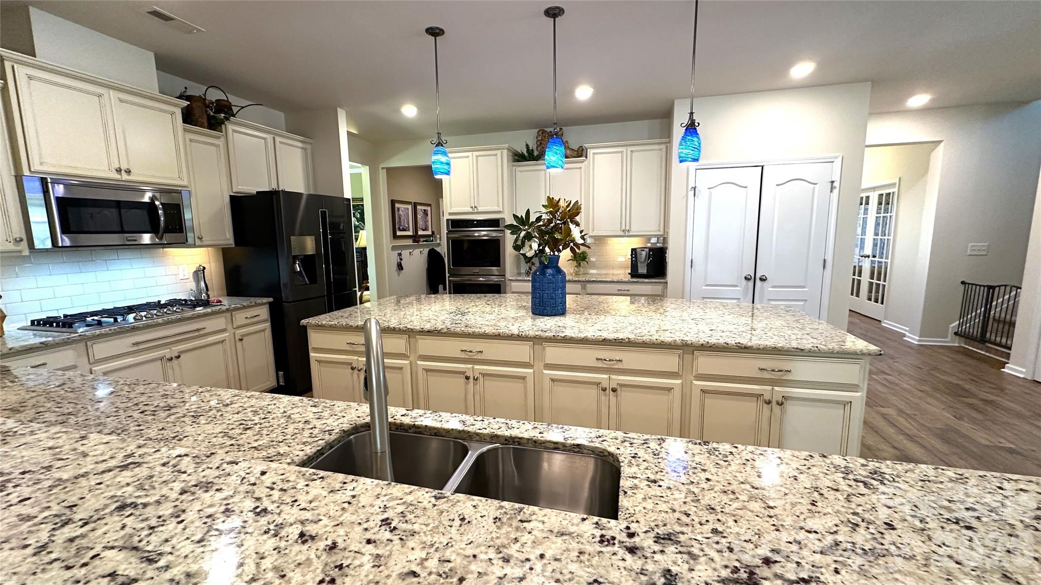 596 Moses Drive Fort Mill, SC 29707 - Photo 7 of 29 a kitchen with kitchen island granite countertop a sink and cabinets