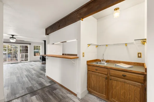 a kitchen with a sink stove and cabinets