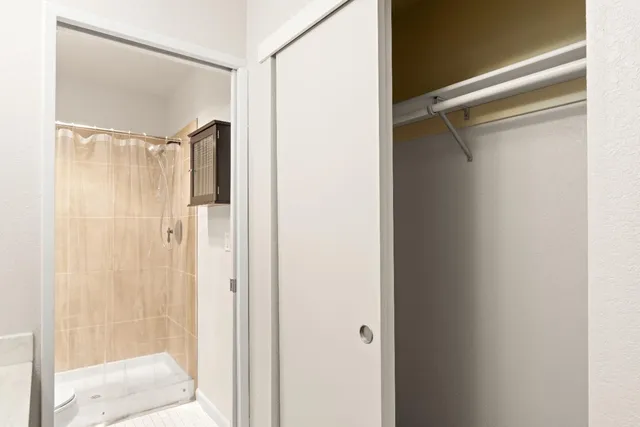 a bathroom with a glass shower door