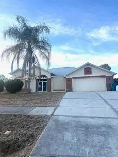 a view of a house with a yard and garage