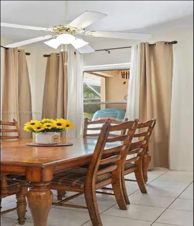 a dining room with furniture and window