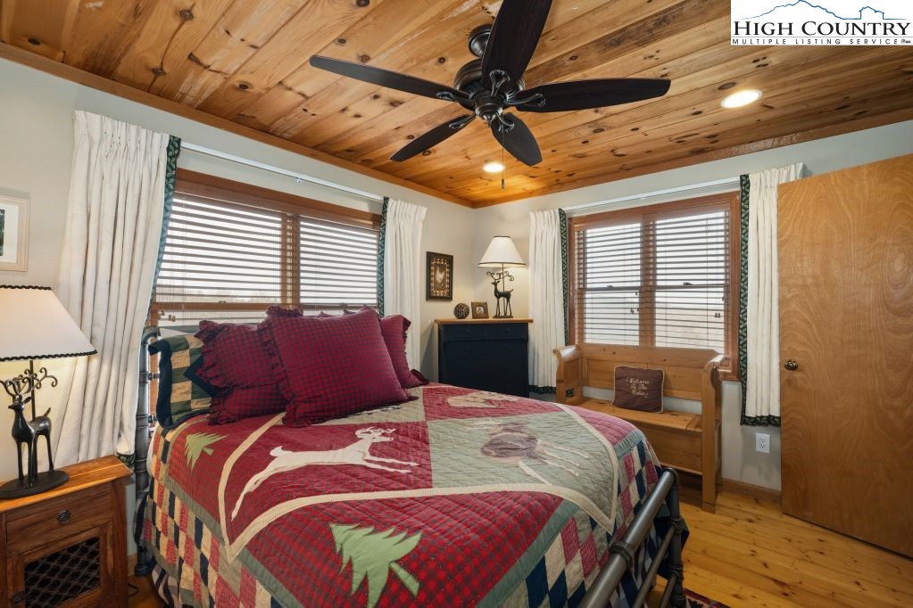 126 Rock Spring Circle Sugar Mountain, NC 28604 - Photo 12 of 29 a bed sitting in a bedroom next to a window