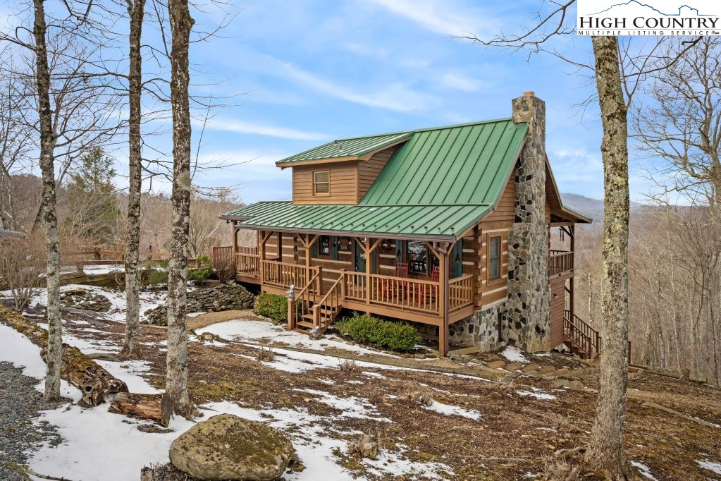 126 Rock Spring Circle Sugar Mountain, NC 28604 - Photo 20 of 29 a front view of a house with a yard