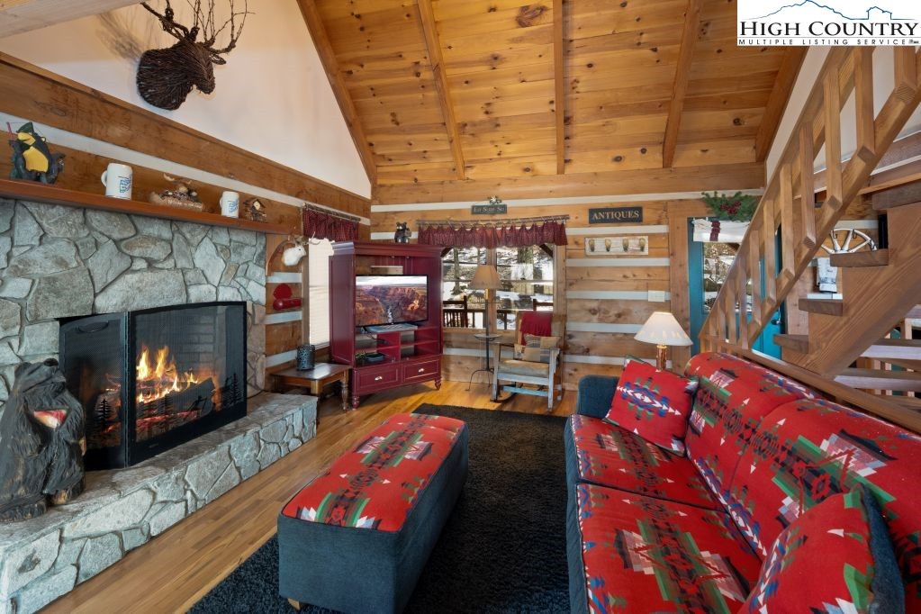126 Rock Spring Circle Sugar Mountain, NC 28604 - Photo 2 of 29 a living room with furniture and a fireplace