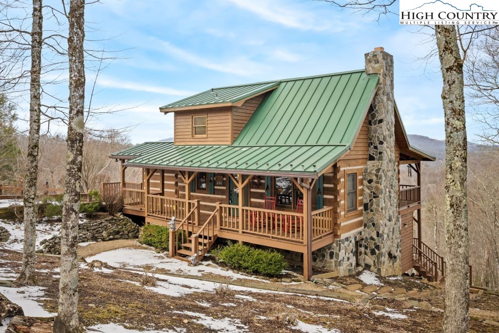 126 Rock Spring Circle Sugar Mountain, NC 28604 - Photo 25 of 29 a view of a house with a yard
