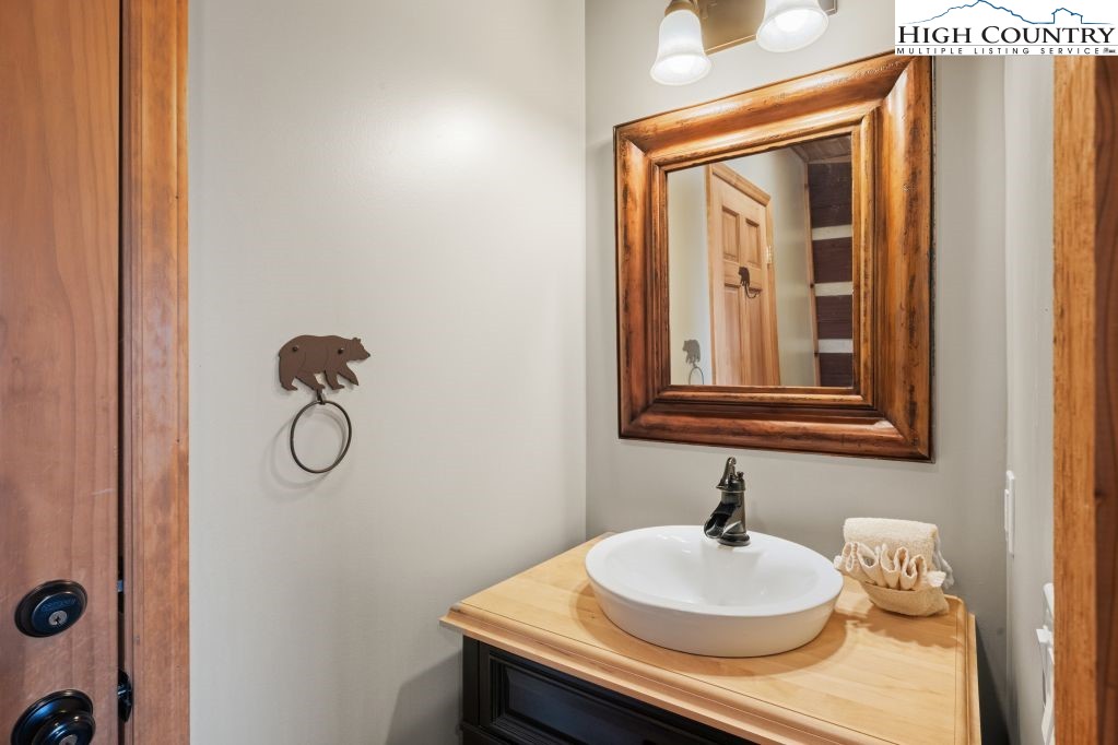 126 Rock Spring Circle Sugar Mountain, NC 28604 - Photo 10 of 29 a bathroom with a sink and a mirror