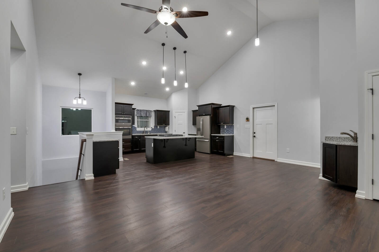 105 Lake Wood Road Lebanon, TN 37087 - Photo 10 of 34 an open kitchen with stainless steel appliances kitchen island a refrigerator and a stove top oven