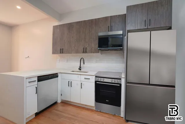 a kitchen with a refrigerator sink and microwave