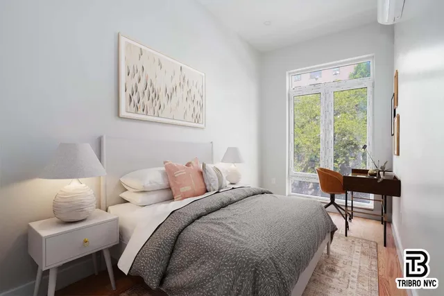 a bedroom with a bed and a windows