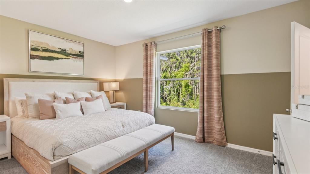 32511 Welling Blade Loop Wesley Chapel, FL 33545 - Photo 20 of 42 a bedroom with a bed and a window