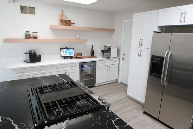 a kitchen with a stove and a refrigerator