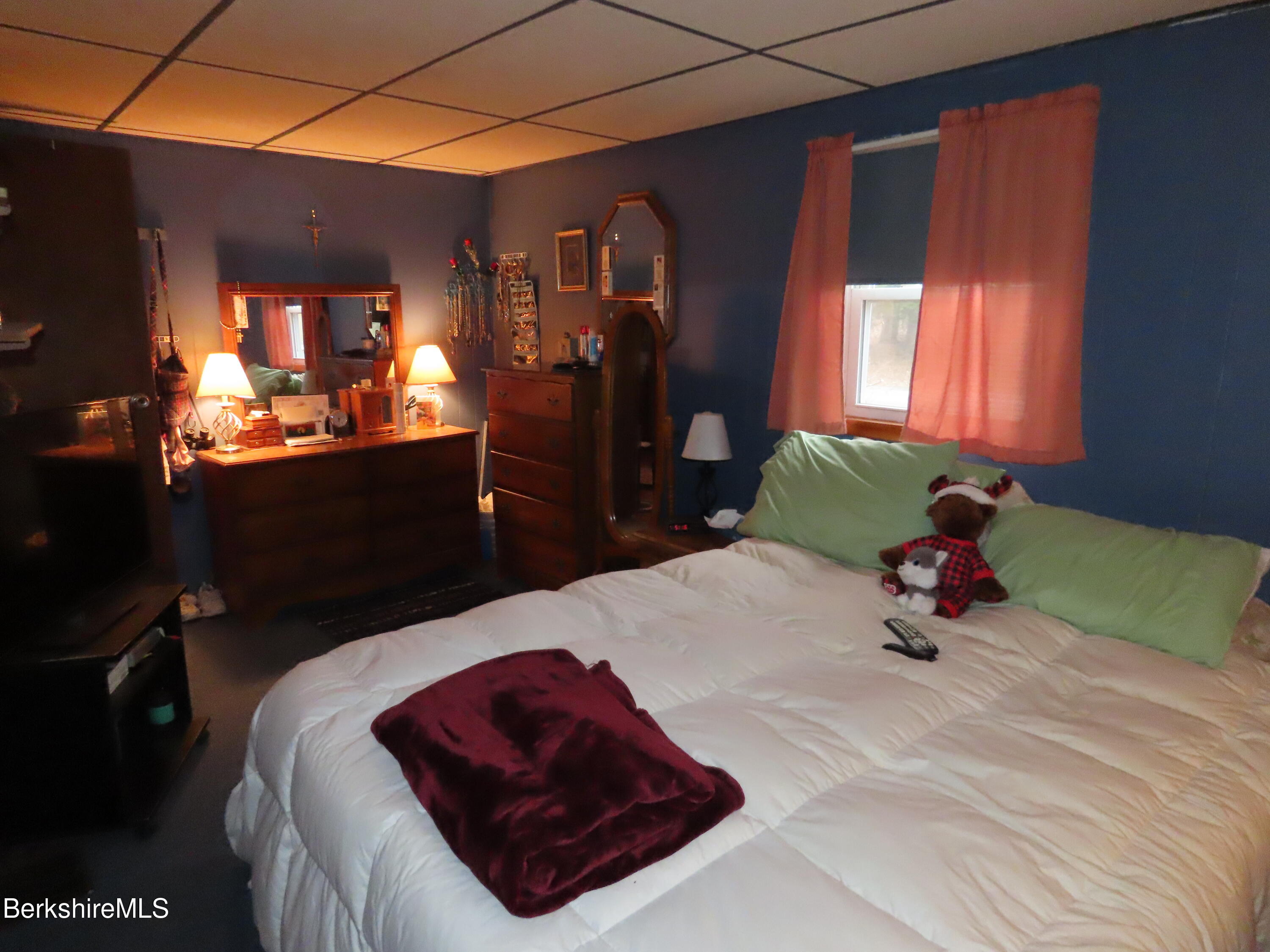 95 E Road Clarksburg, MA 01247 - Photo 19 of 28 a bedroom with a bed and a chandelier