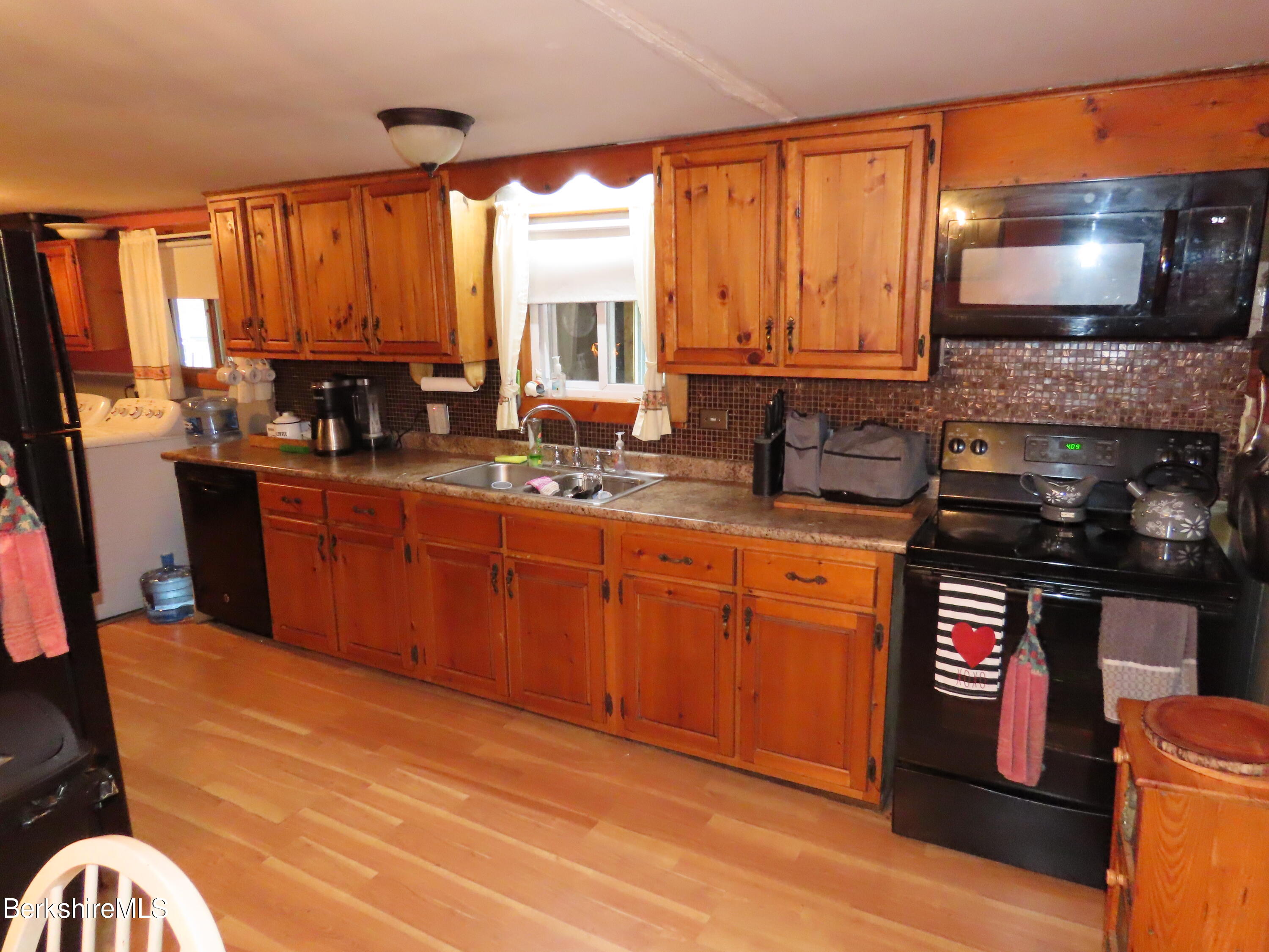 95 E Road Clarksburg, MA 01247 - Photo 3 of 28 a kitchen with stainless steel appliances granite countertop a stove sink and cabinets