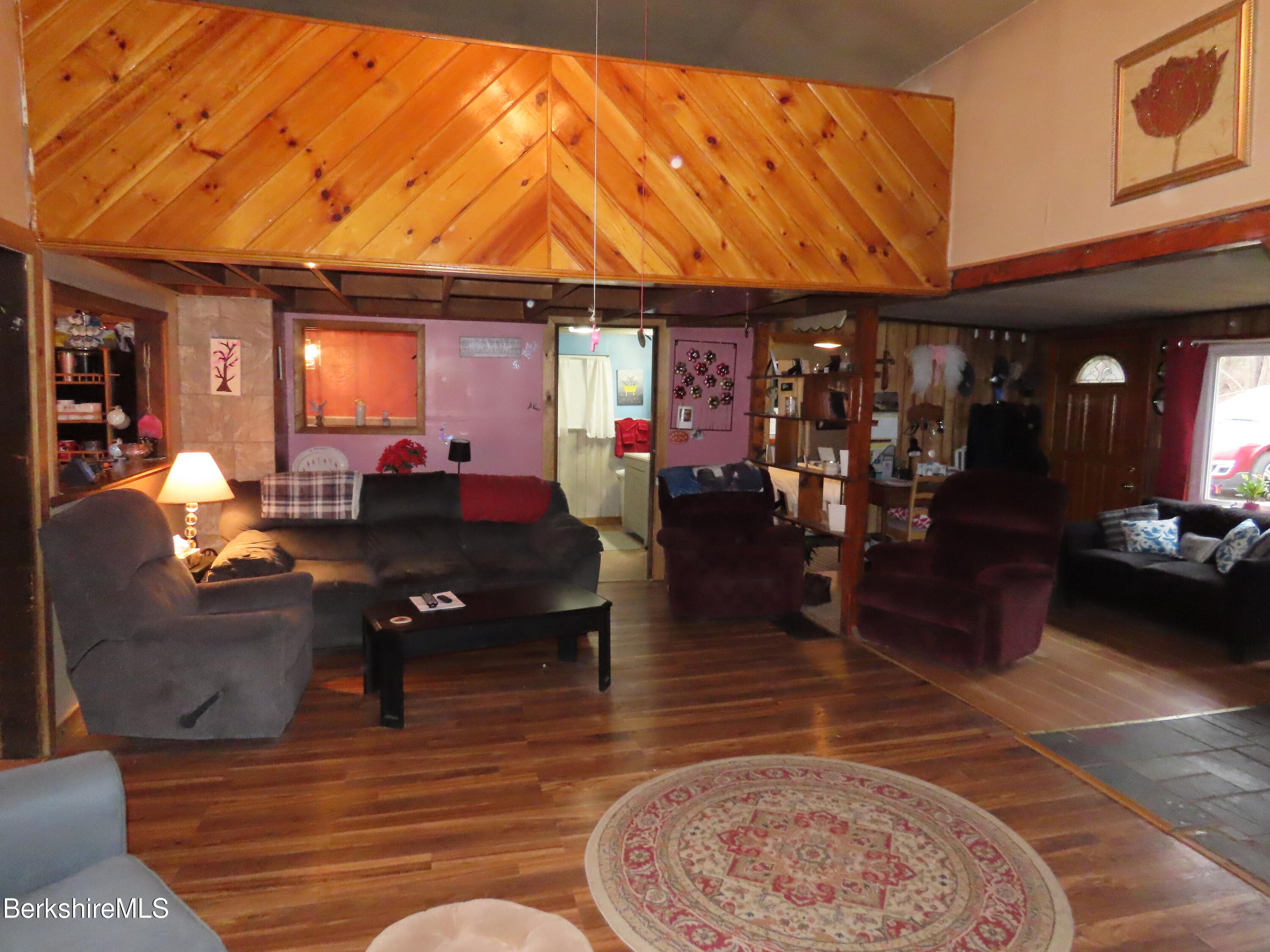 95 E Road Clarksburg, MA 01247 - Photo 8 of 28 a living room with furniture a rug and a chandelier