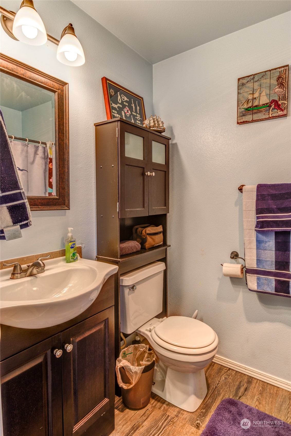 1663 South 48th Street Tacoma, WA 98408 - Photo 15 of 25 a bathroom with a toilet a sink and a mirror