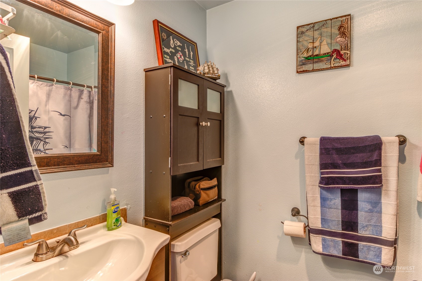 1663 South 48th Street Tacoma, WA 98408 - Photo 16 of 25 a bathroom with a sink and a mirror