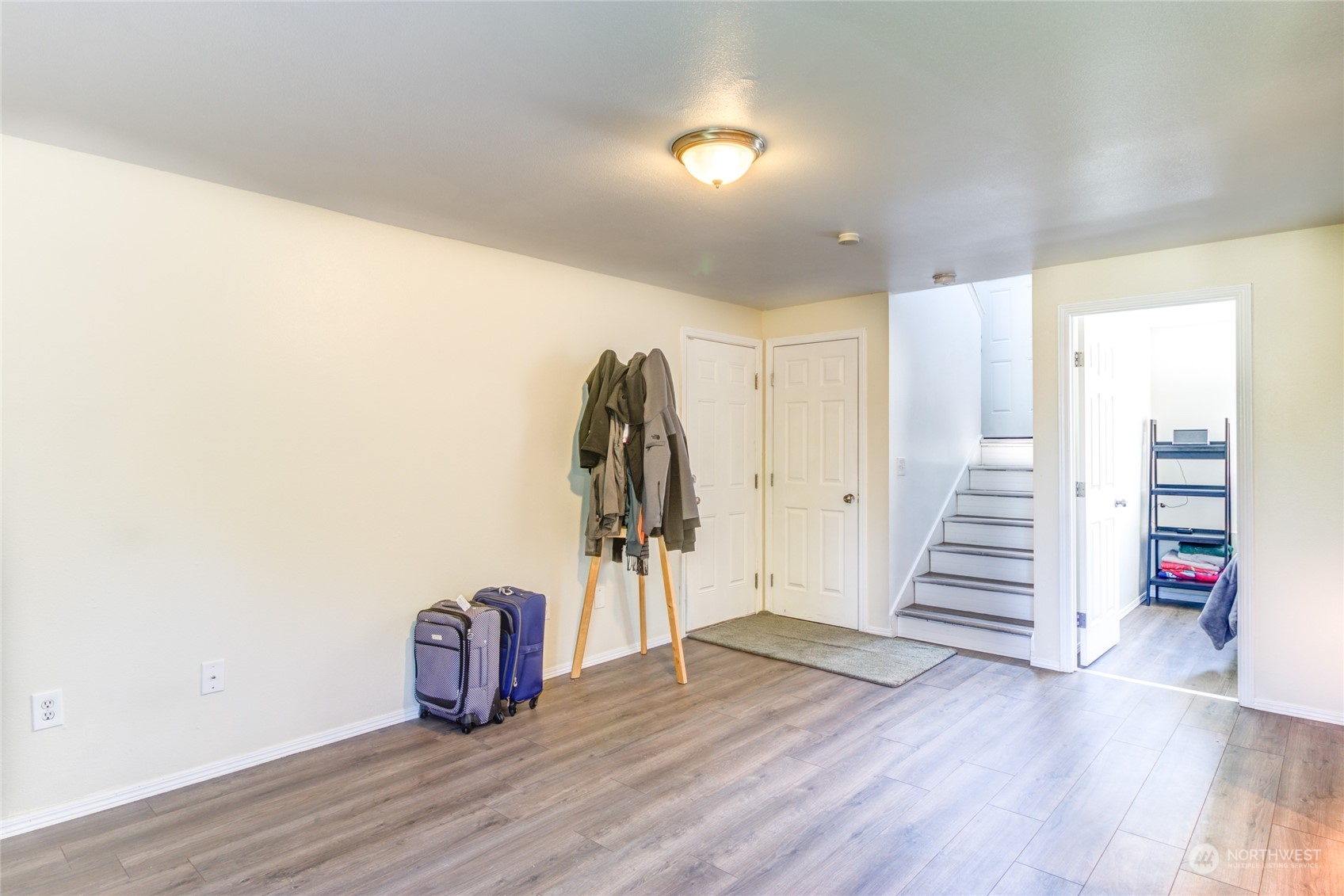 1663 South 48th Street Tacoma, WA 98408 - Photo 18 of 25 a view of a livingroom with wooden floor and stairs
