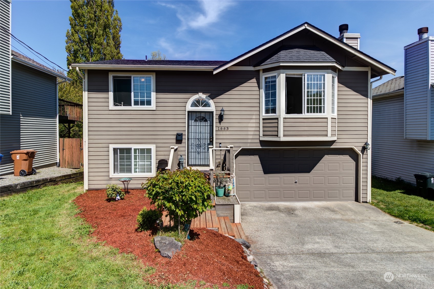1663 South 48th Street Tacoma, WA 98408 - Photo 2 of 25 a front view of a house with a yard