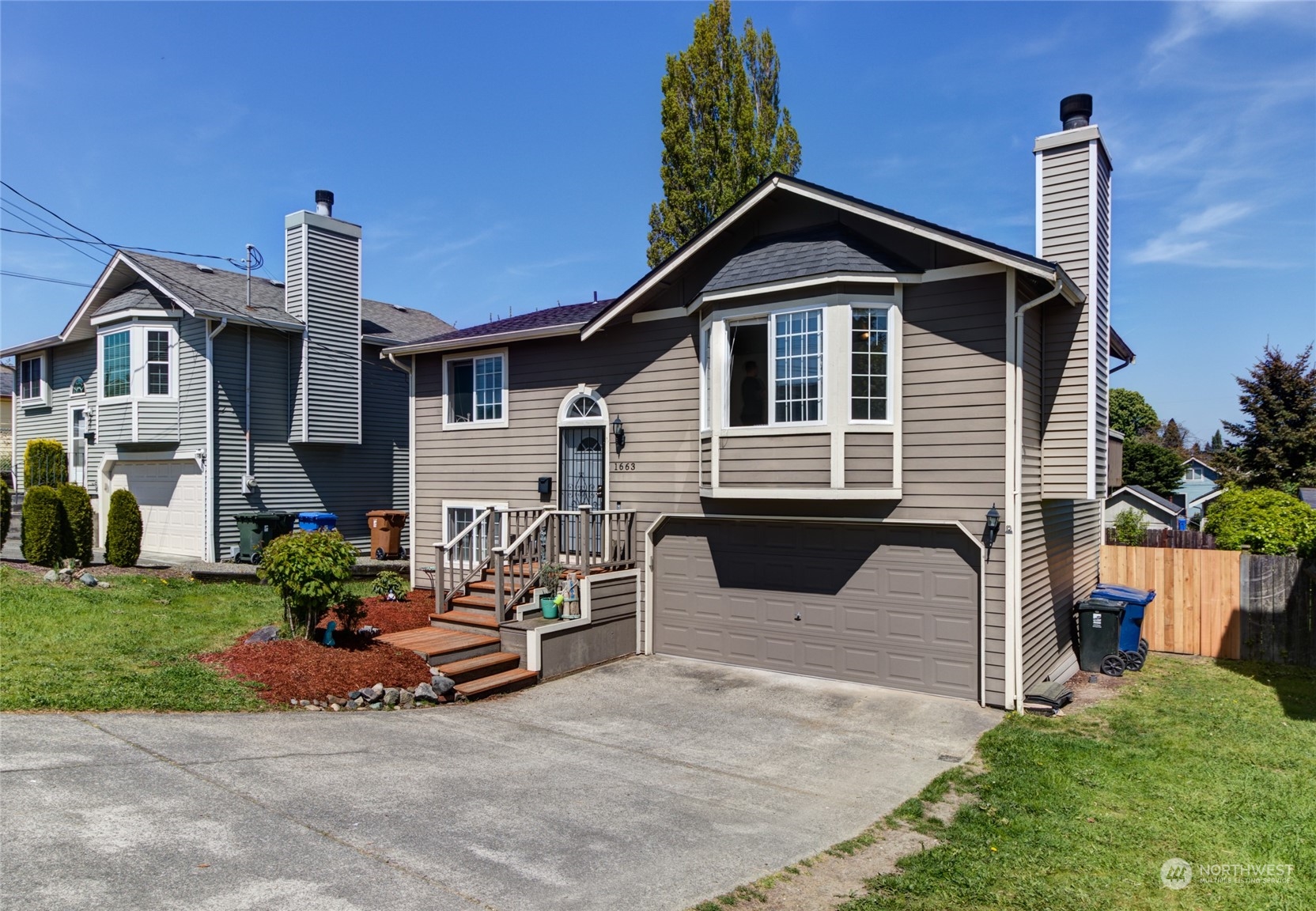 1663 South 48th Street Tacoma, WA 98408 - Photo 3 of 25 a front view of a house with garden