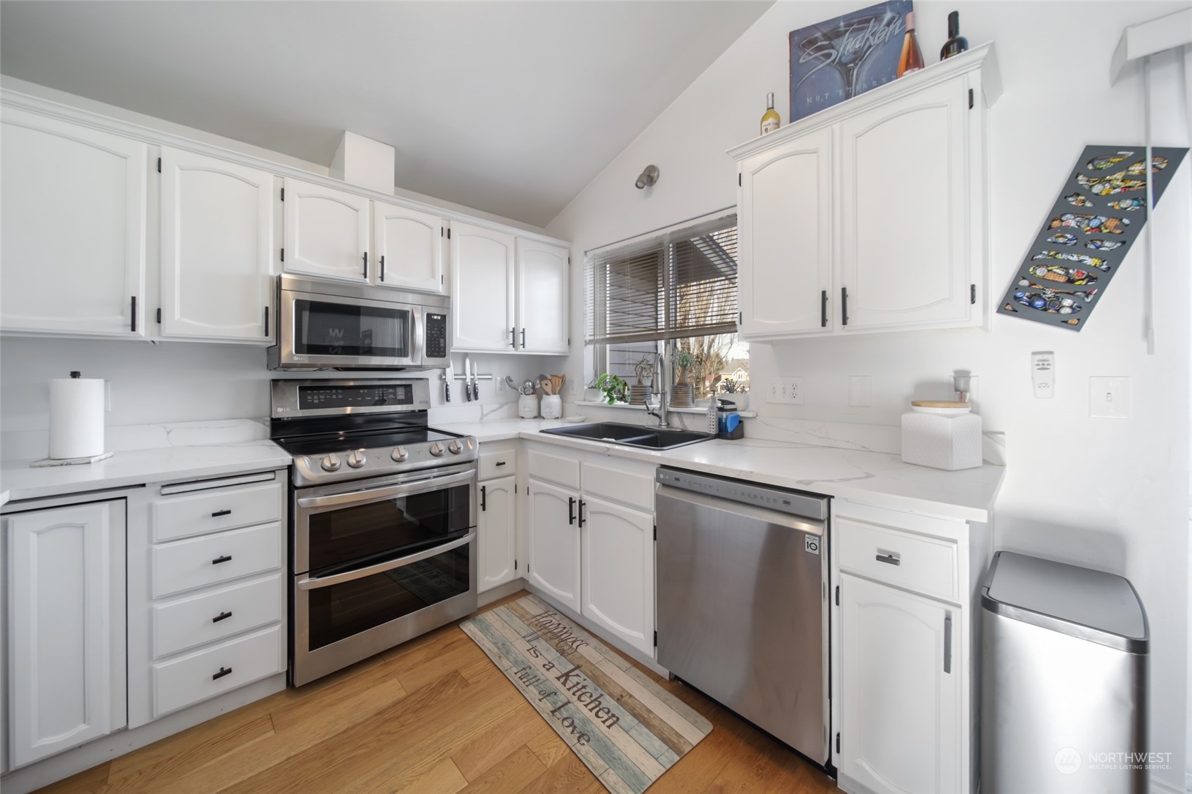 1663 South 48th Street Tacoma, WA 98408 - Photo 5 of 25 a kitchen with white cabinets and appliances