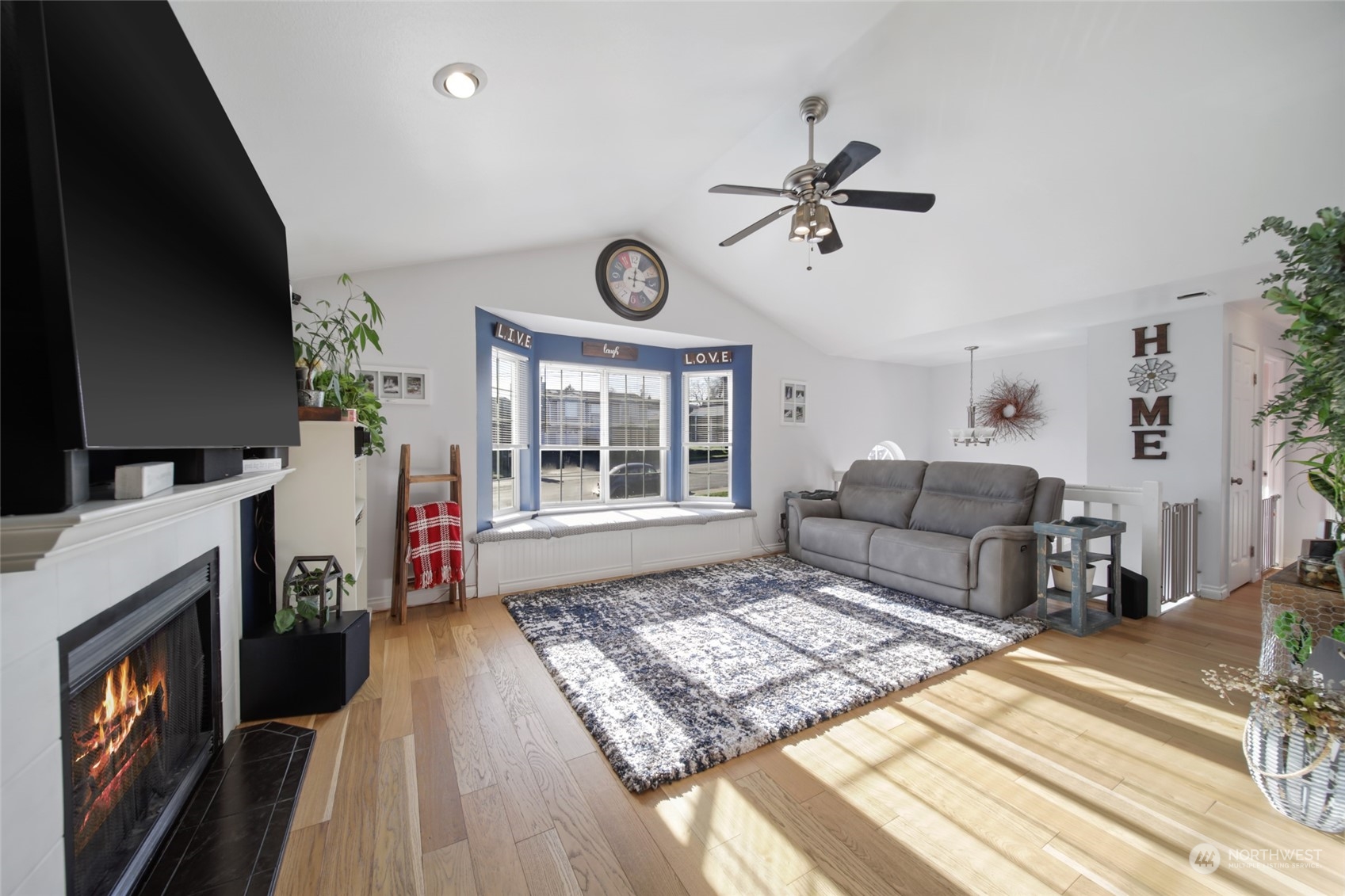 1663 South 48th Street Tacoma, WA 98408 - Photo 7 of 25 a living room with furniture a fireplace and a flat screen tv