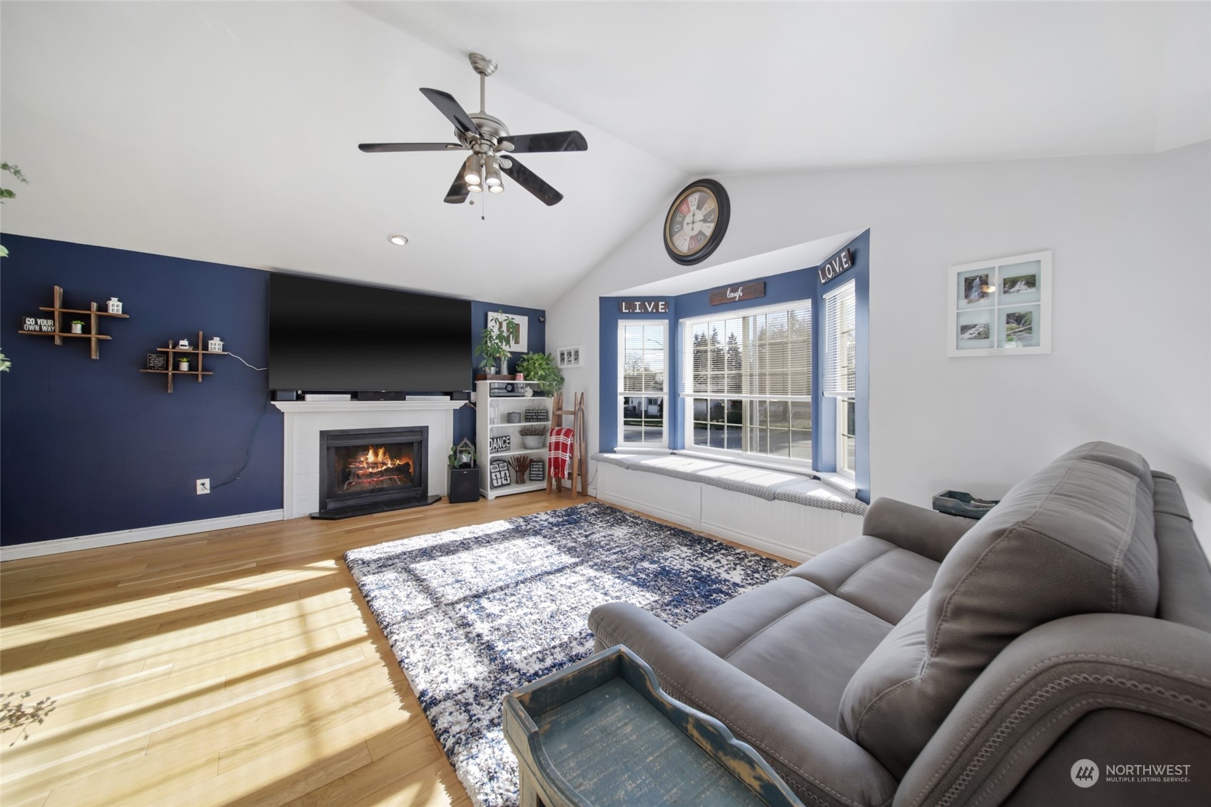 1663 South 48th Street Tacoma, WA 98408 - Photo 8 of 25 a living room with furniture a fireplace and a flat screen tv