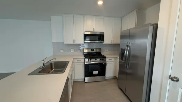 a kitchen with a refrigerator sink and stove
