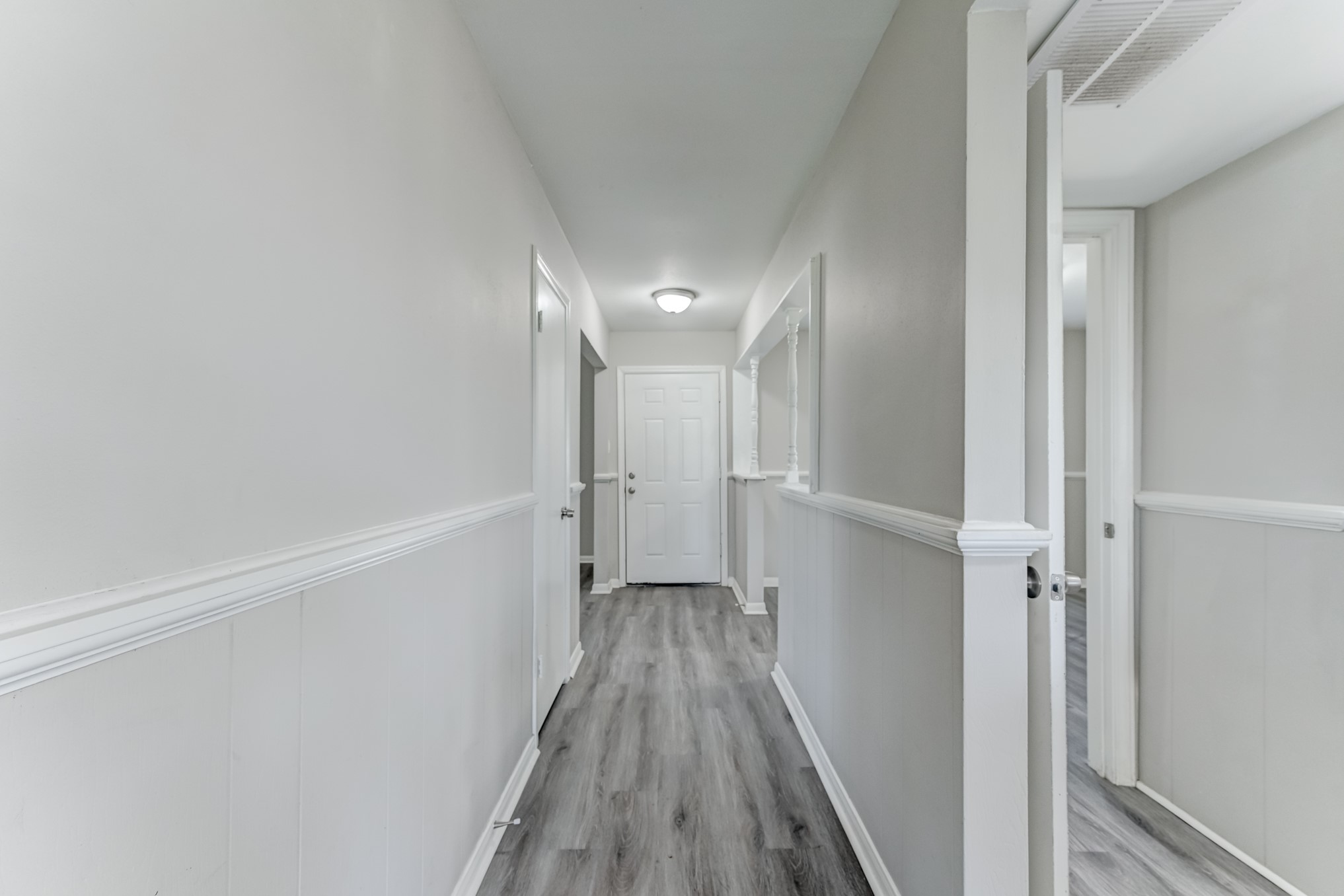 12415 Foxburo Drive Houston, TX 77065 - Photo 12 of 43 a view of a hallway with wooden floor and a ceiling fan