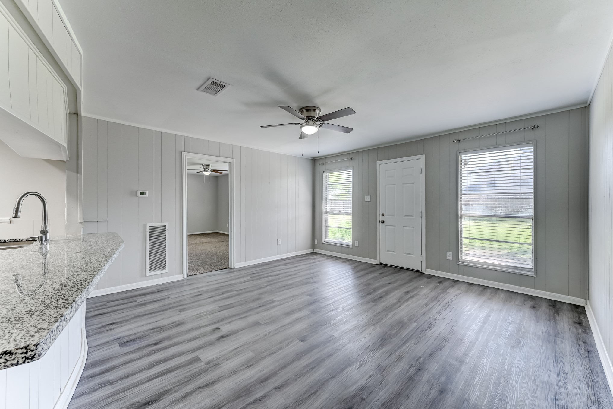 12415 Foxburo Drive Houston, TX 77065 - Photo 13 of 43 a view of an empty room with a window and wooden floor