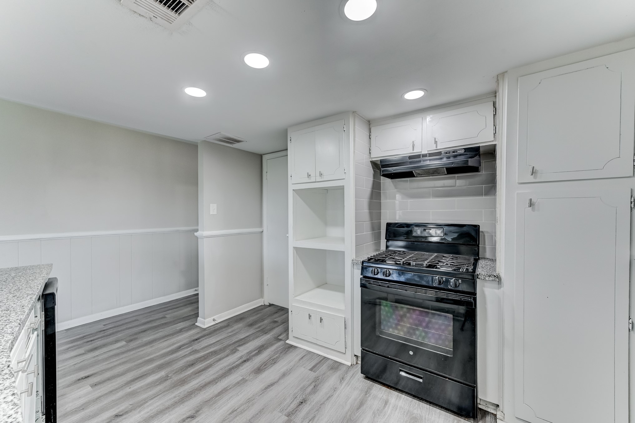 12415 Foxburo Drive Houston, TX 77065 - Photo 16 of 43 a kitchen with wooden floor and a stove top oven