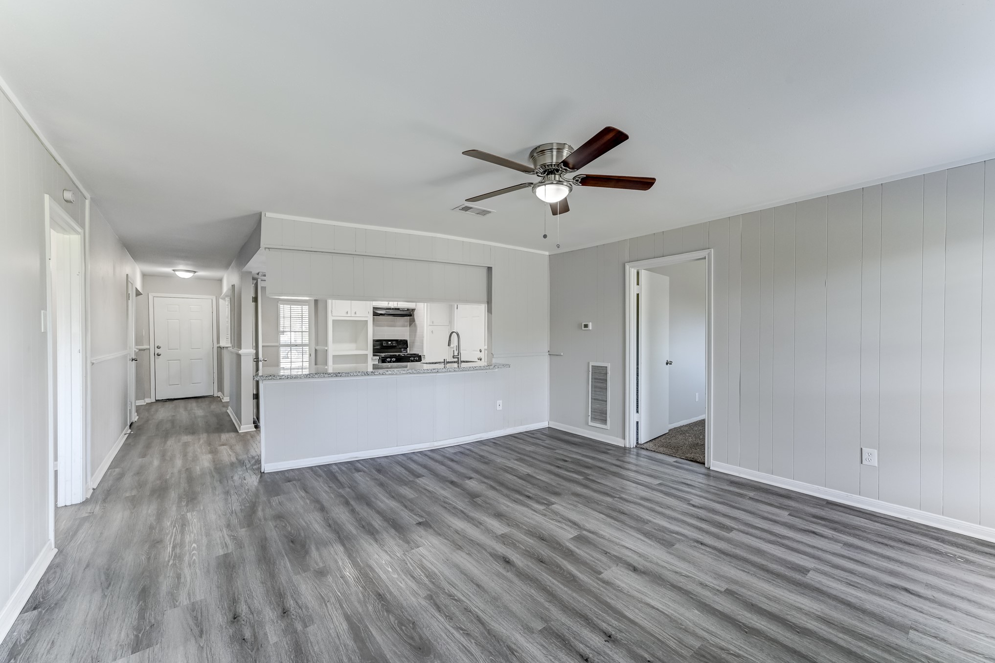 12415 Foxburo Drive Houston, TX 77065 - Photo 22 of 43 a view of a living room hardwood floor and a kitchen