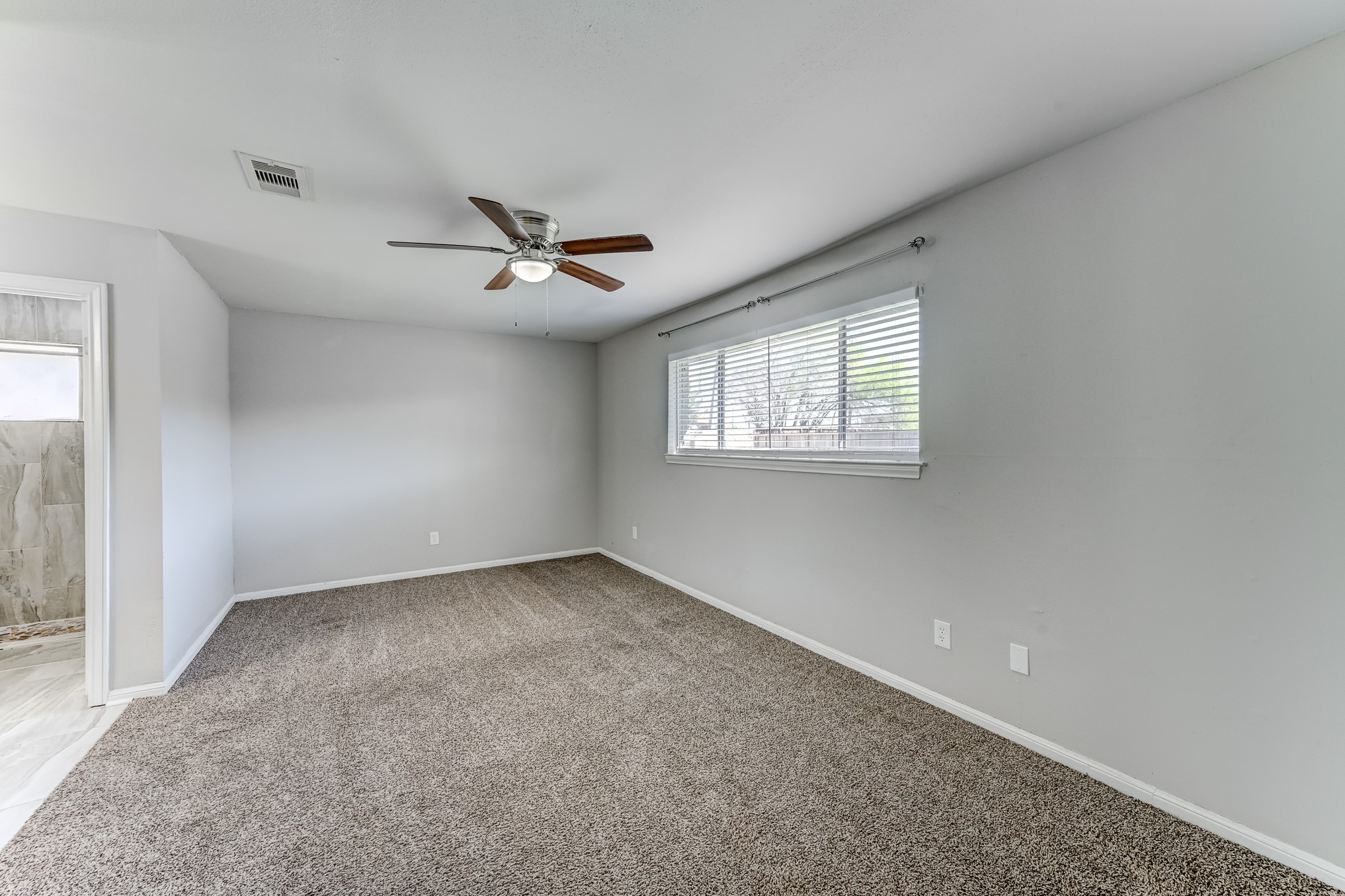 12415 Foxburo Drive Houston, TX 77065 - Photo 24 of 43 an empty room with windows and ceiling fan