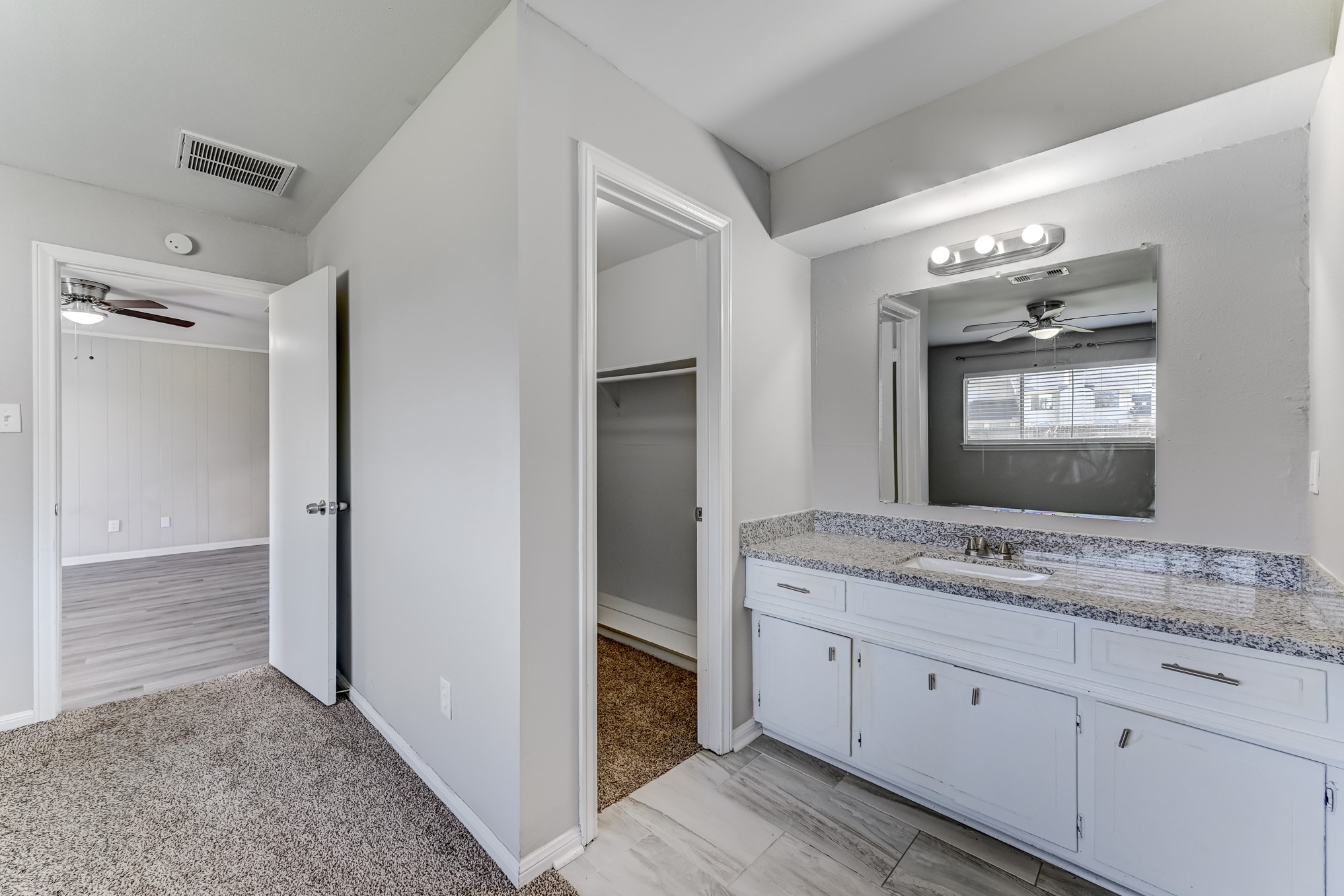 12415 Foxburo Drive Houston, TX 77065 - Photo 29 of 43 a bathroom with a granite countertop sink mirror and cabinets