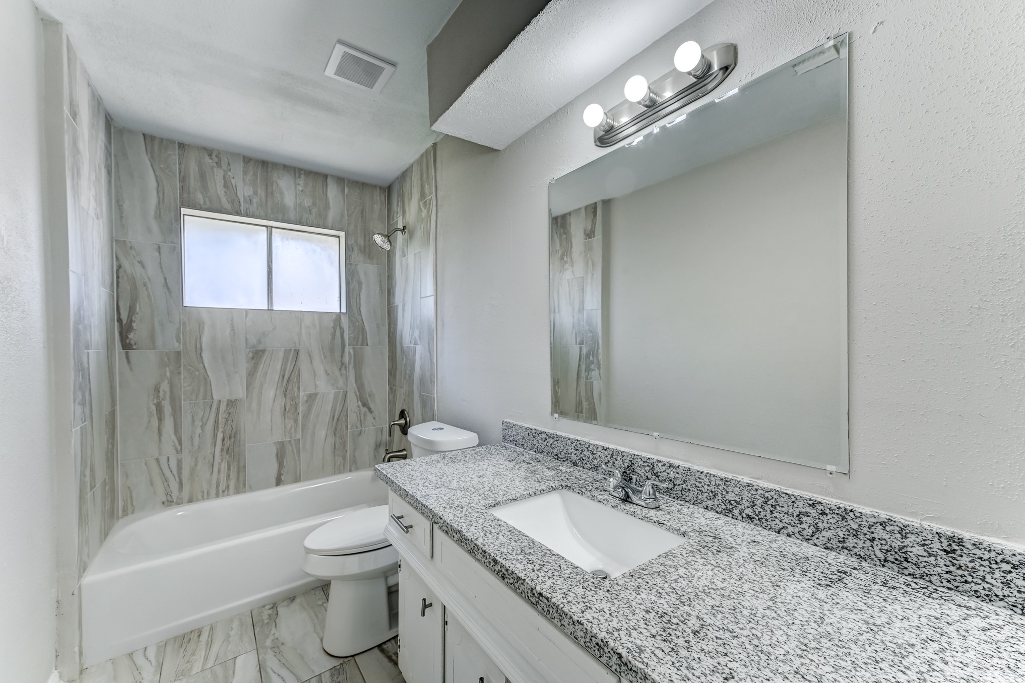 12415 Foxburo Drive Houston, TX 77065 - Photo 35 of 43 a bathroom with a granite countertop sink a toilet a mirror and shower