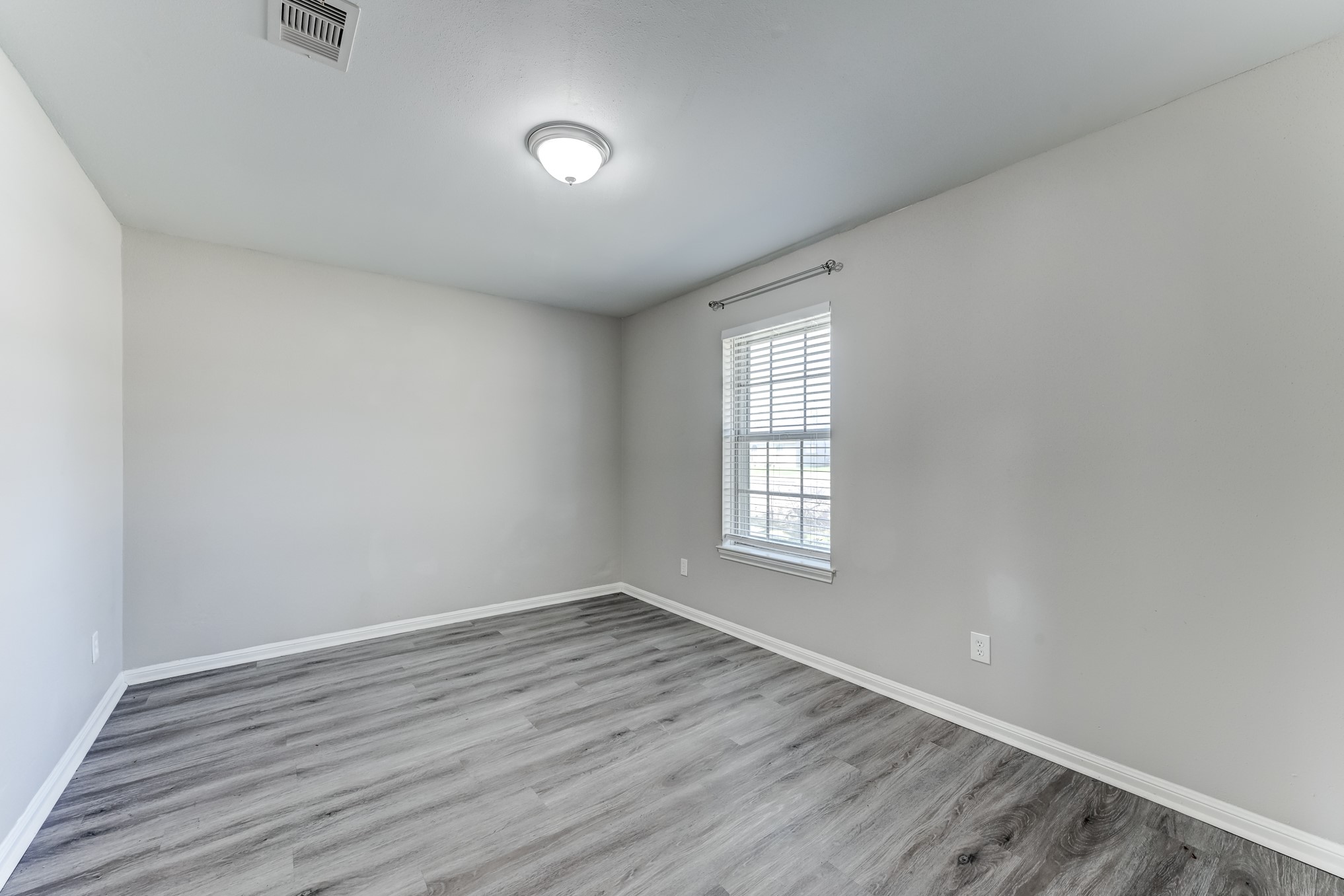 12415 Foxburo Drive Houston, TX 77065 - Photo 9 of 43 an empty room with wooden floor and windows