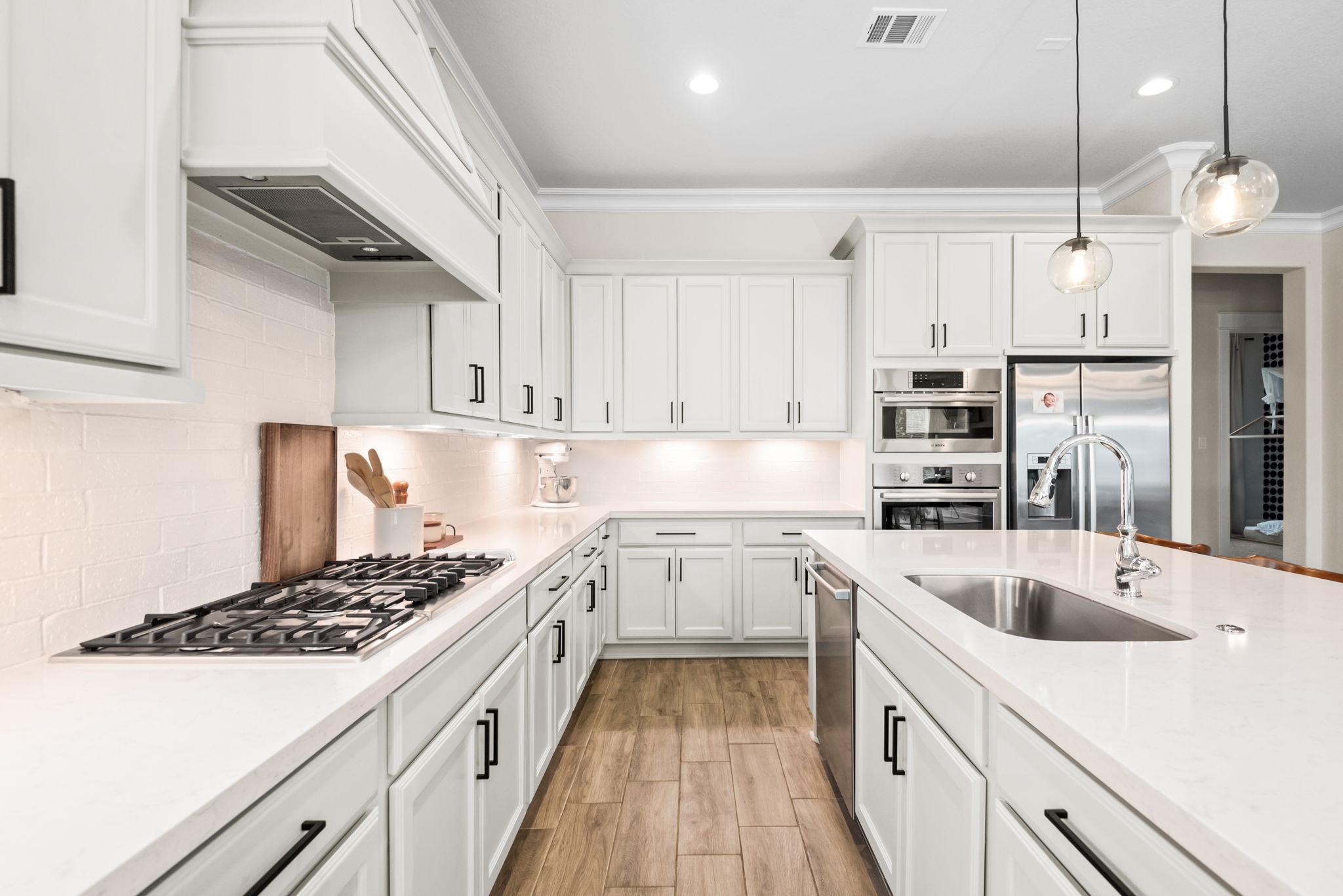 2335 Pale Star Drive Conroe, TX 77384 - Photo 17 of 42 a kitchen with a sink stove and cabinets