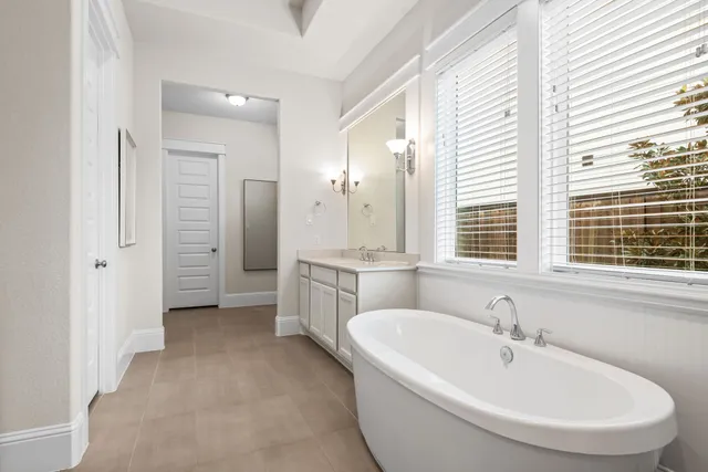 a white bath tub sitting next to a window