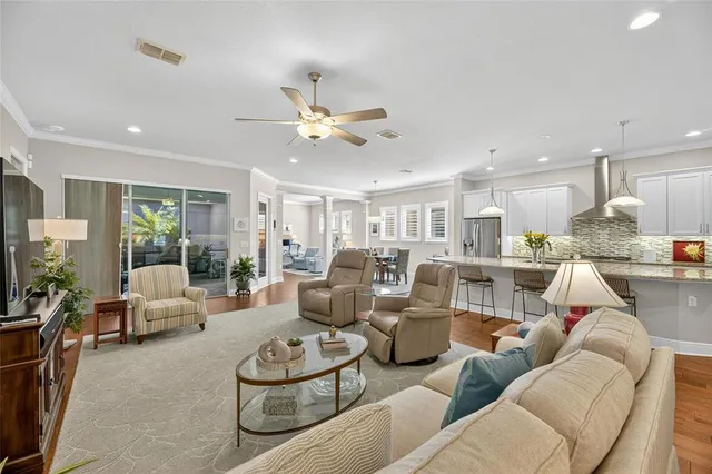 a kitchen with kitchen island a counter top space a sink stainless steel appliances and cabinets