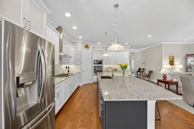 a kitchen with stainless steel appliances granite countertop white cabinets and a granite counter tops