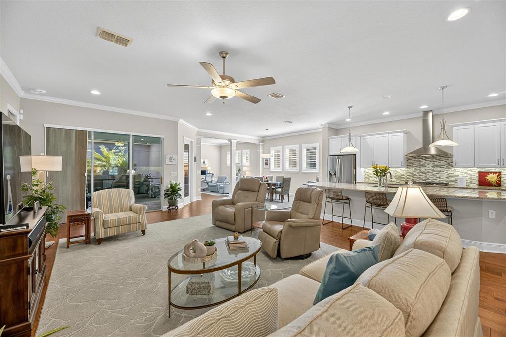 6002 Sparrowhead Way Lithia, FL 33547 - Photo 14 of 57 a living room with furniture kitchen view and a chandelier