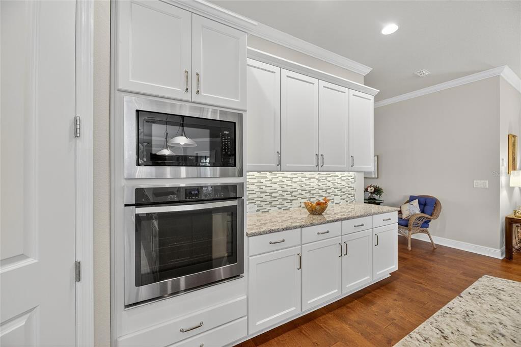 6002 Sparrowhead Way Lithia, FL 33547 - Photo 22 of 57 a kitchen with stainless steel appliances a stove microwave and cabinets