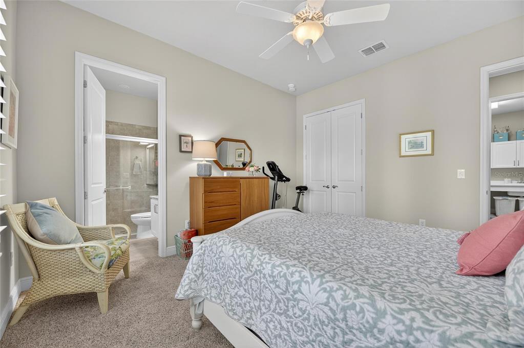 6002 Sparrowhead Way Lithia, FL 33547 - Photo 23 of 55 a bedroom with a bed a chandelier and dresser