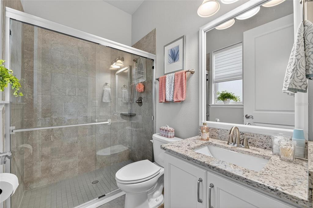 6002 Sparrowhead Way Lithia, FL 33547 - Photo 26 of 57 a bathroom with a granite countertop sink toilet and shower