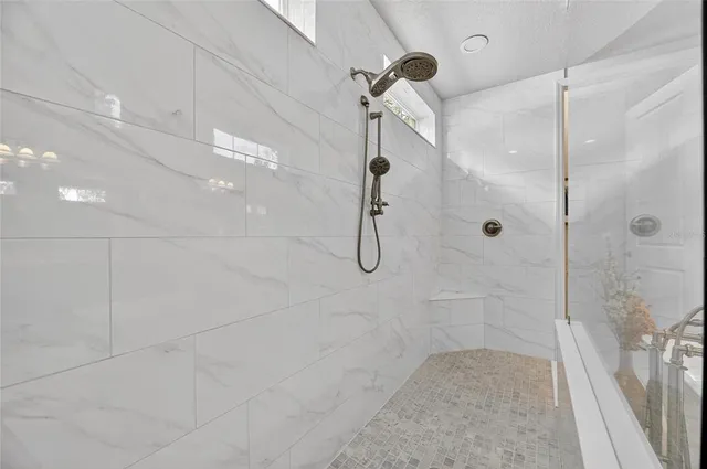a large bathroom with a large mirror vanity and sink