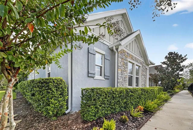 a man sitting on a bed in front of a house