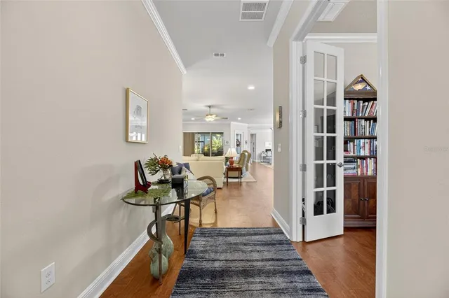a view of a hallway with wooden floor and staircase