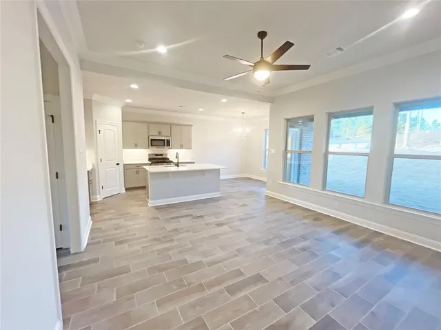 a view of a kitchen with a sink and a refrigerator