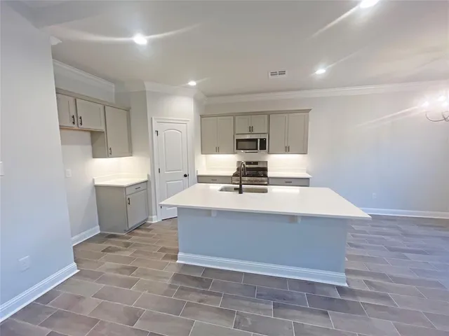 a view of kitchen with sink microwave and refrigerator