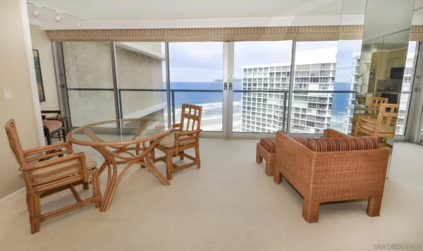 a living room with furniture and a floor to ceiling window
